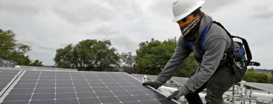 Gen Nashimoto, of Luminalt, installs solar panels