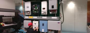Researchers setting up Hardware-in-the-Loop testing to validate the EASE control architecture.