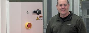 Founder and CEO David Meyers with a DC Fast Charger
