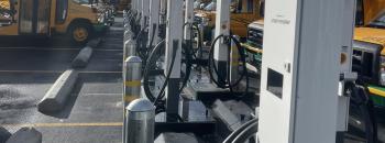 Bidirectional DC EVSE with EV Buses in the background.  